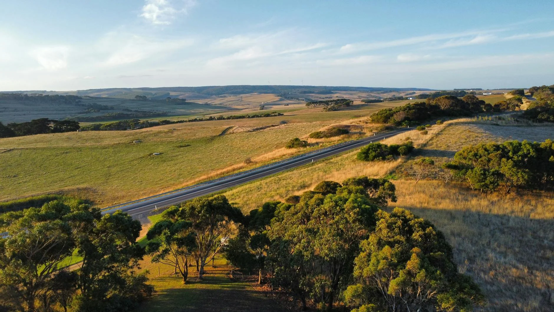Open pastoral stage with the Alps holding the eastern horizon